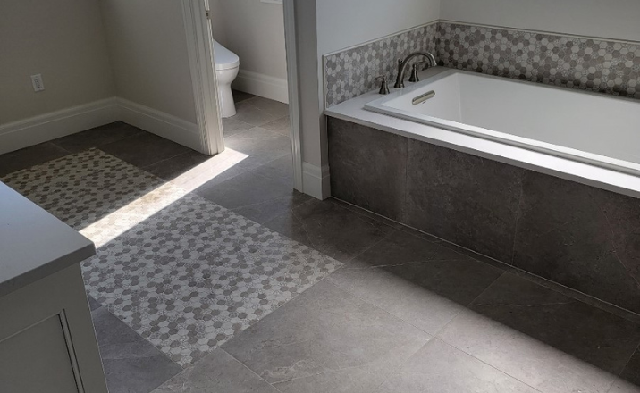 bathroom remodel with tile and white bathtub